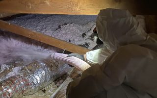 technician put insulation in the attic