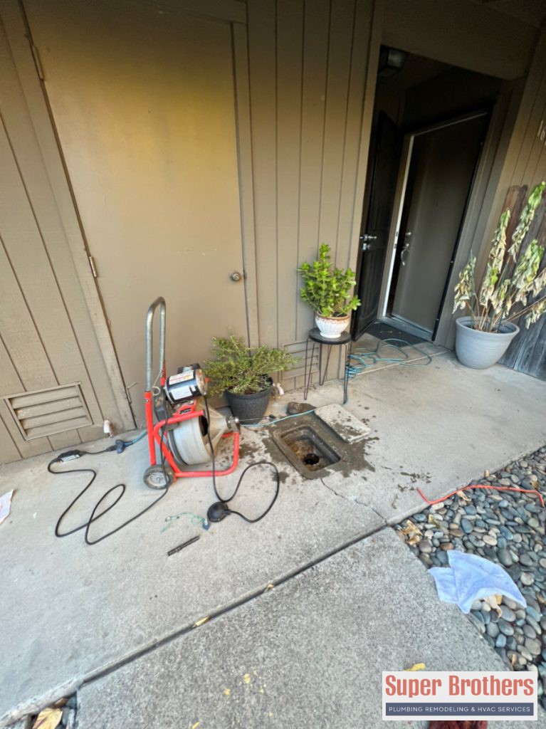 drain cleaning with drain machine through clean out