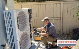 professional technician installing heat pump mini split