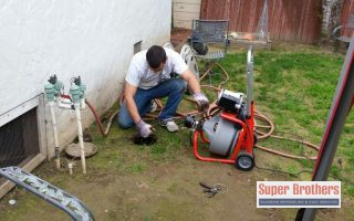 plumber performing drain cleaning service