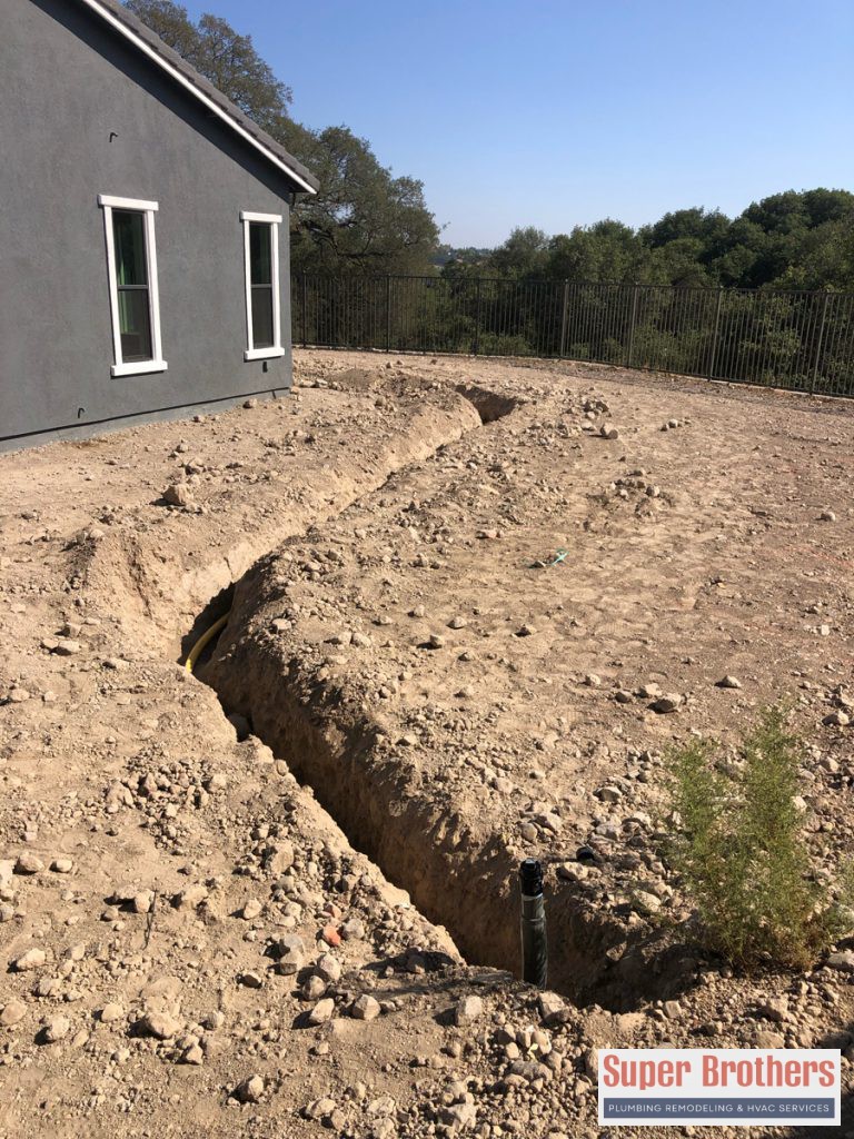 installing new polybutylene pipe for outdoor barbecue
