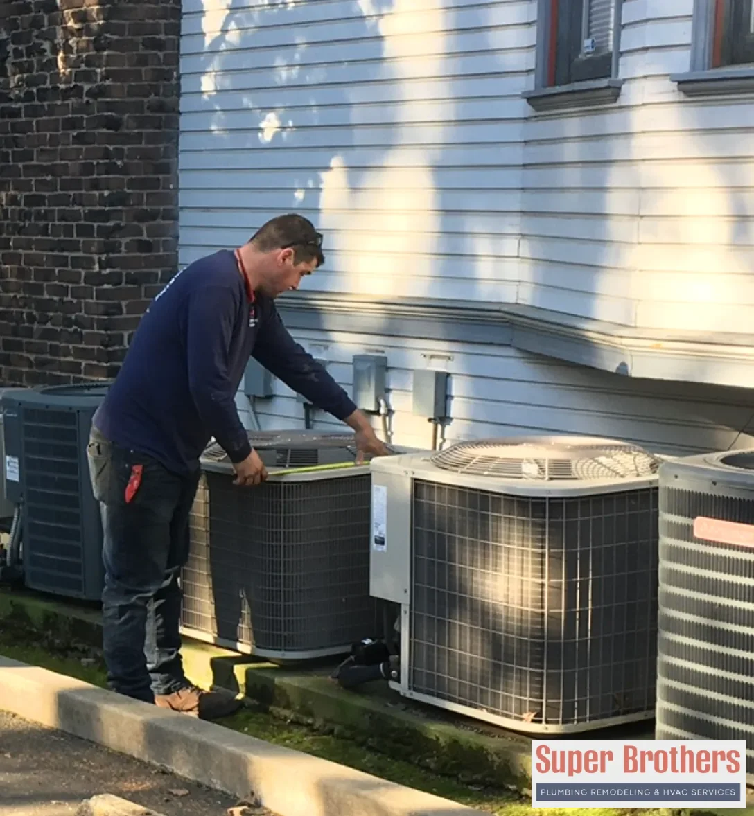 HVAC technician servicing a Sacramento air conditioner during summer heat