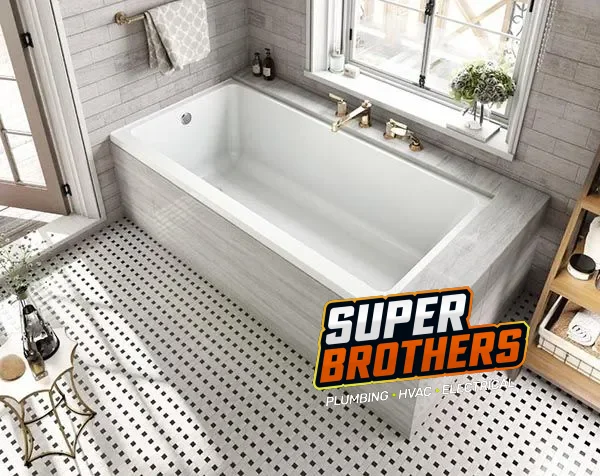 New bathtub with a tiled surround in a remodeled bathroom