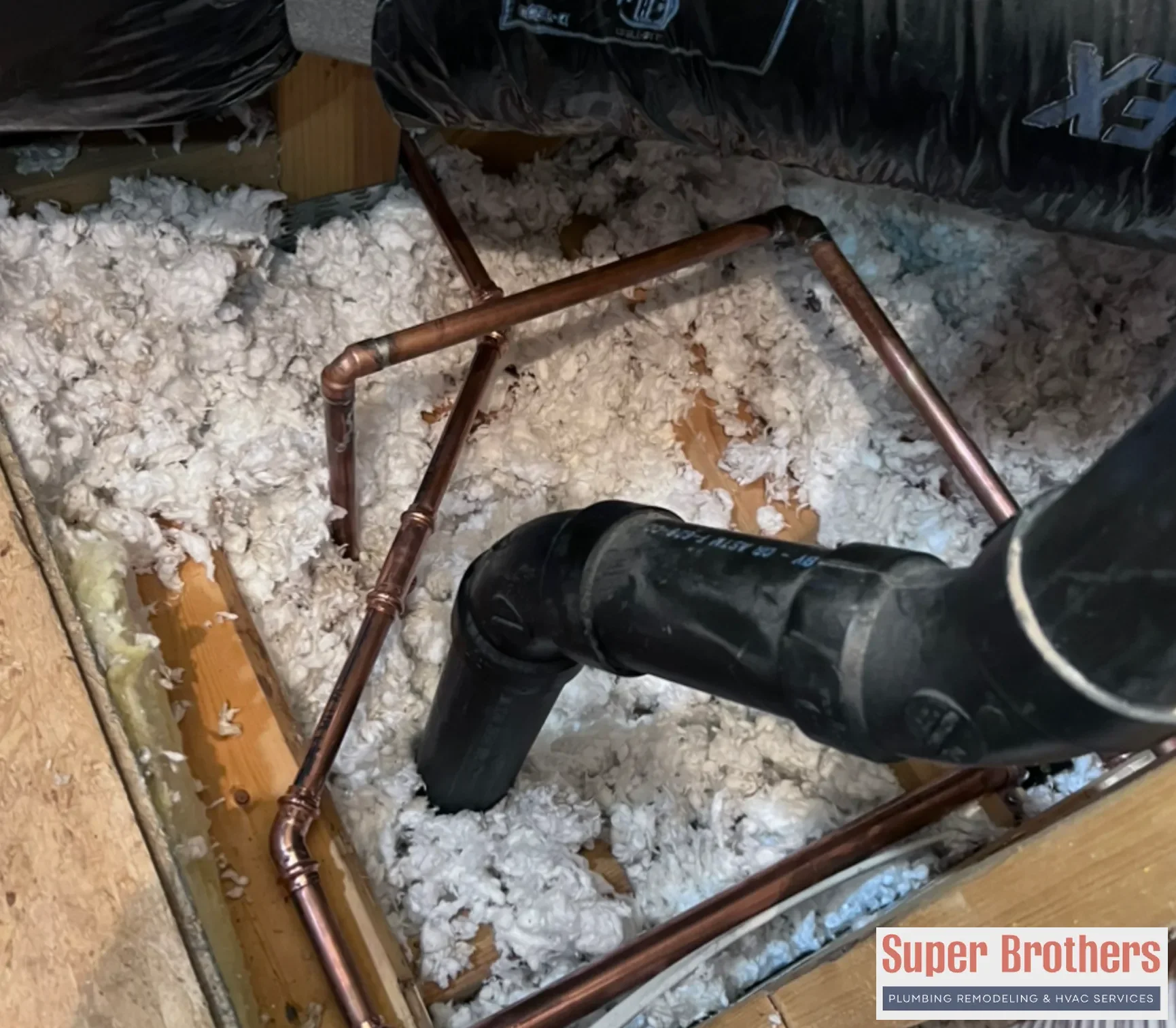 Plumber reviewing old house plumbing lines before a repipe