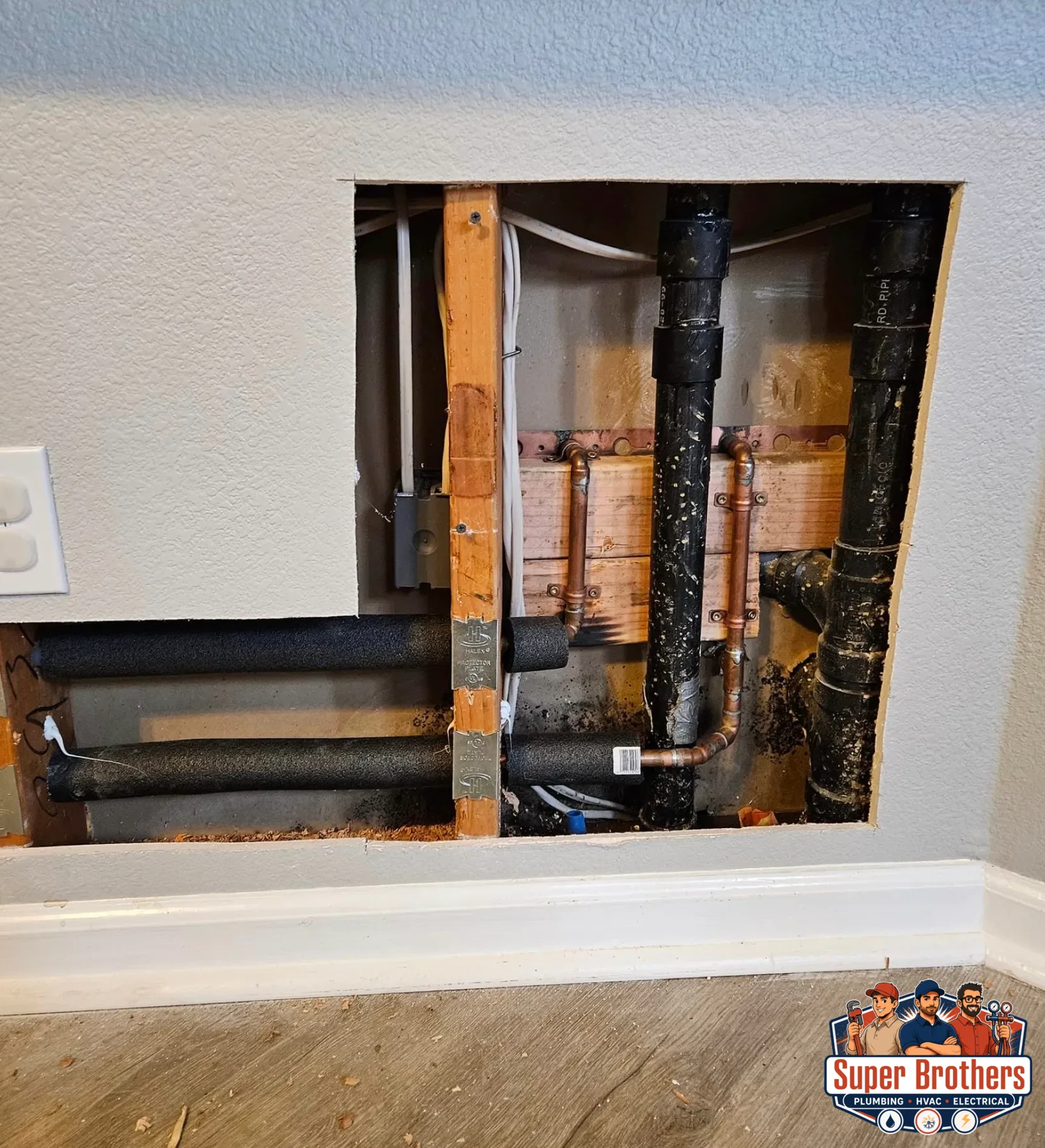 open wall in residential house during repipe process