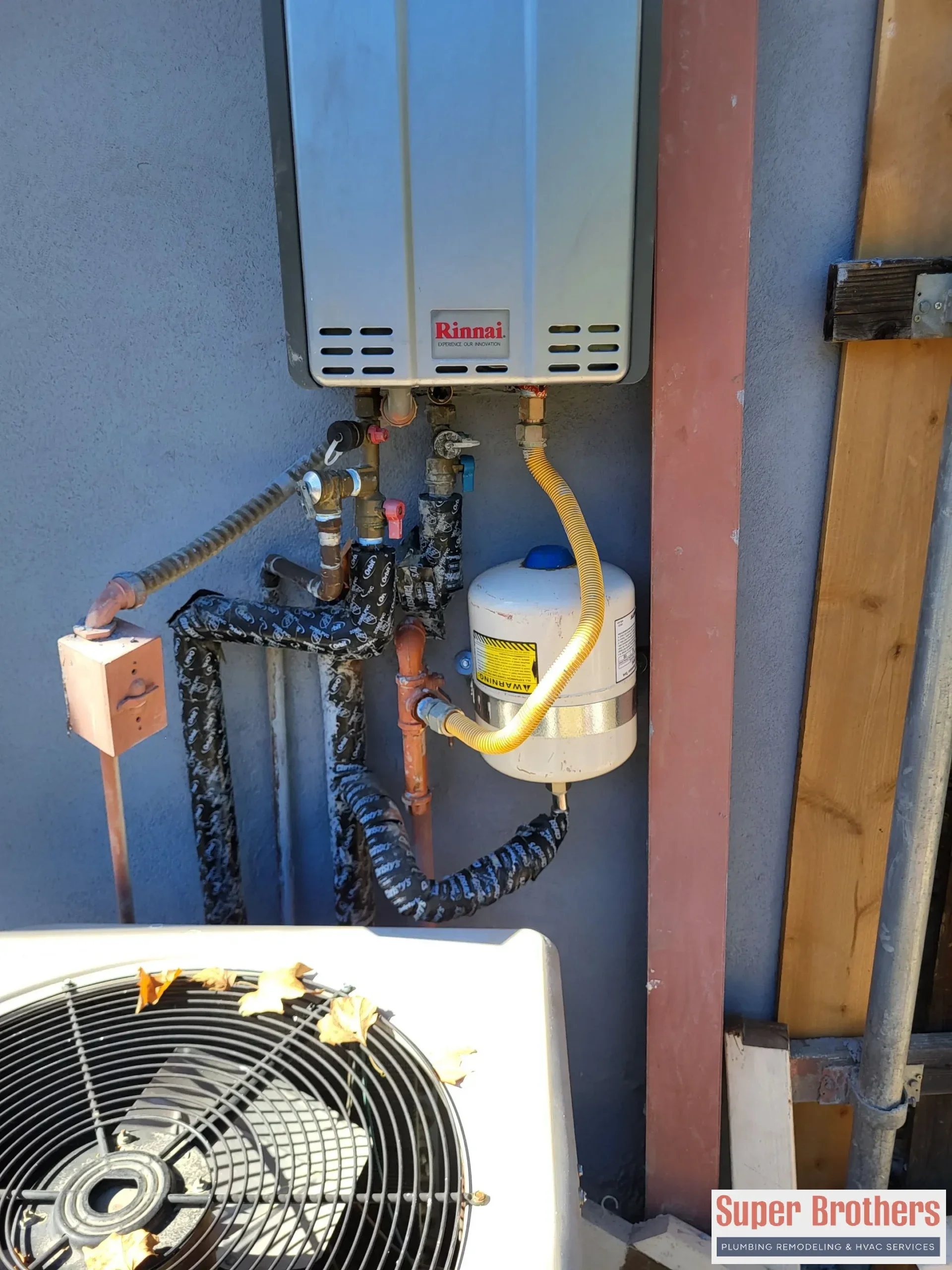 Wall mounted tankless water heater with recirculation pump in a utility room