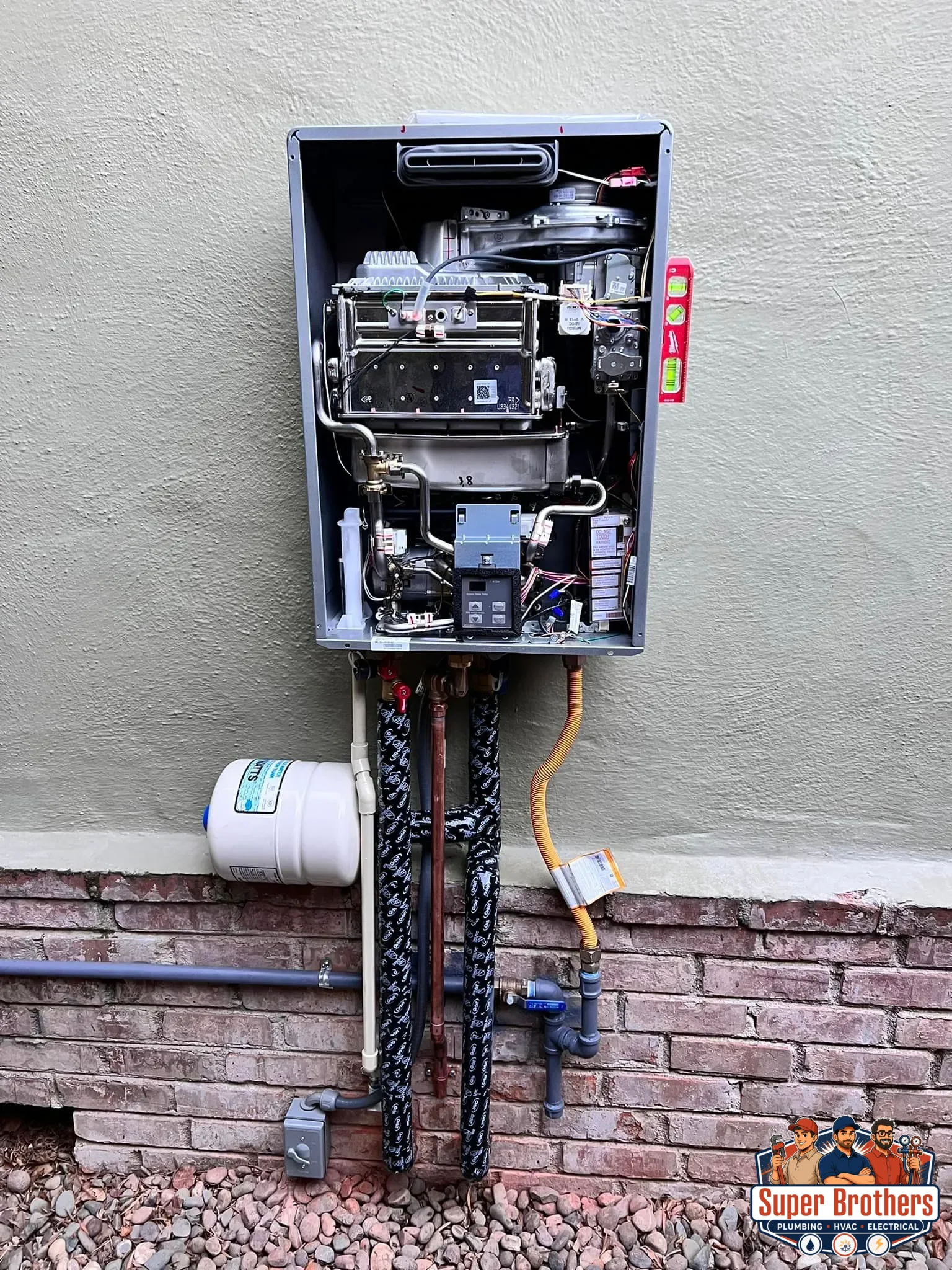Plumber installing piping for a tankless water heater recirculation system