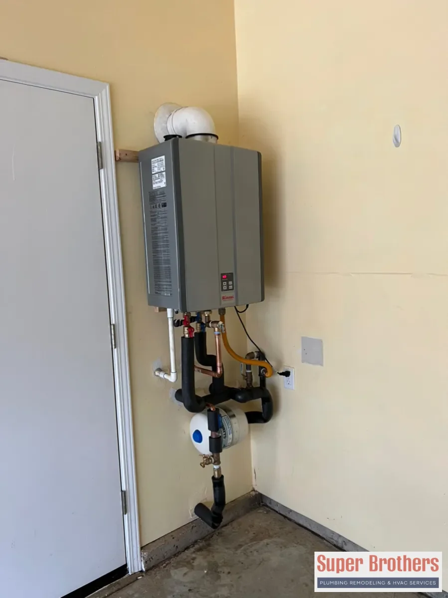 Tankless water heater installed on a wall with service valves and venting in Sacramento home