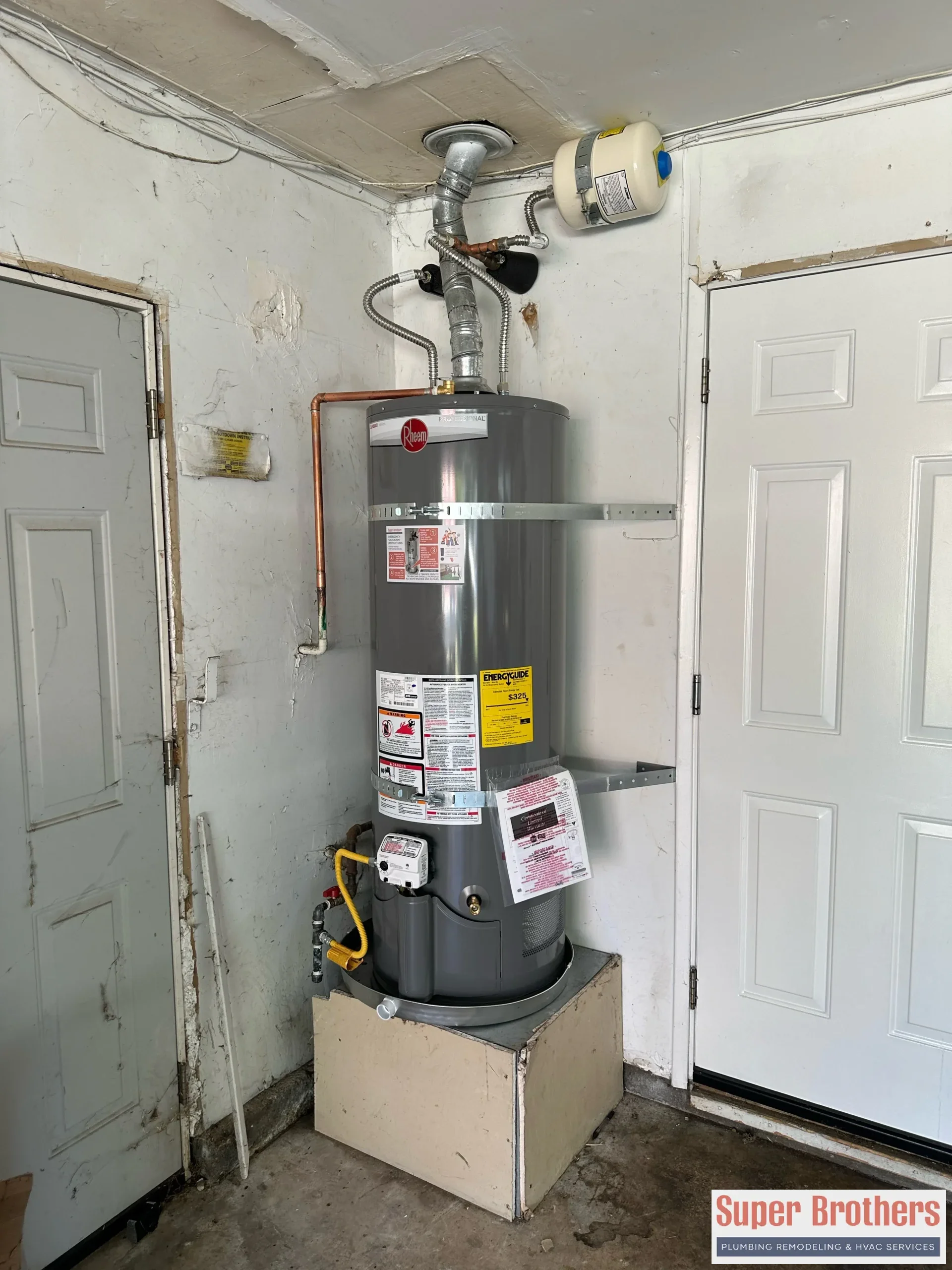 Modern water heater installed in a Sacramento garage with clean piping and bright lighting