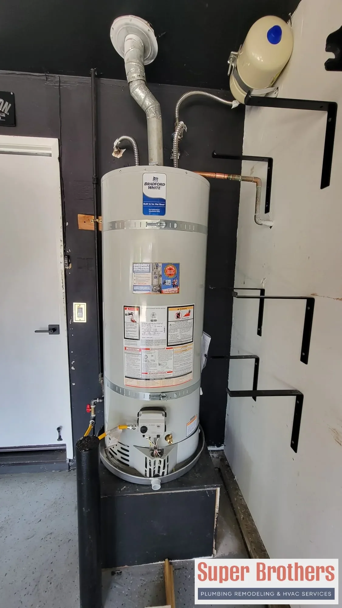 Tank water heater in a Sacramento garage with shutoff valve and expansion tank