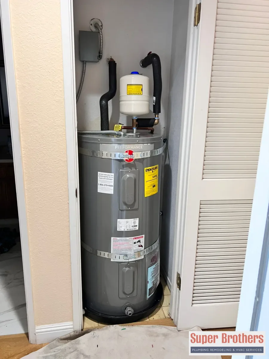Heat pump water heater installed with proper clearance and condensate drain in Sacramento