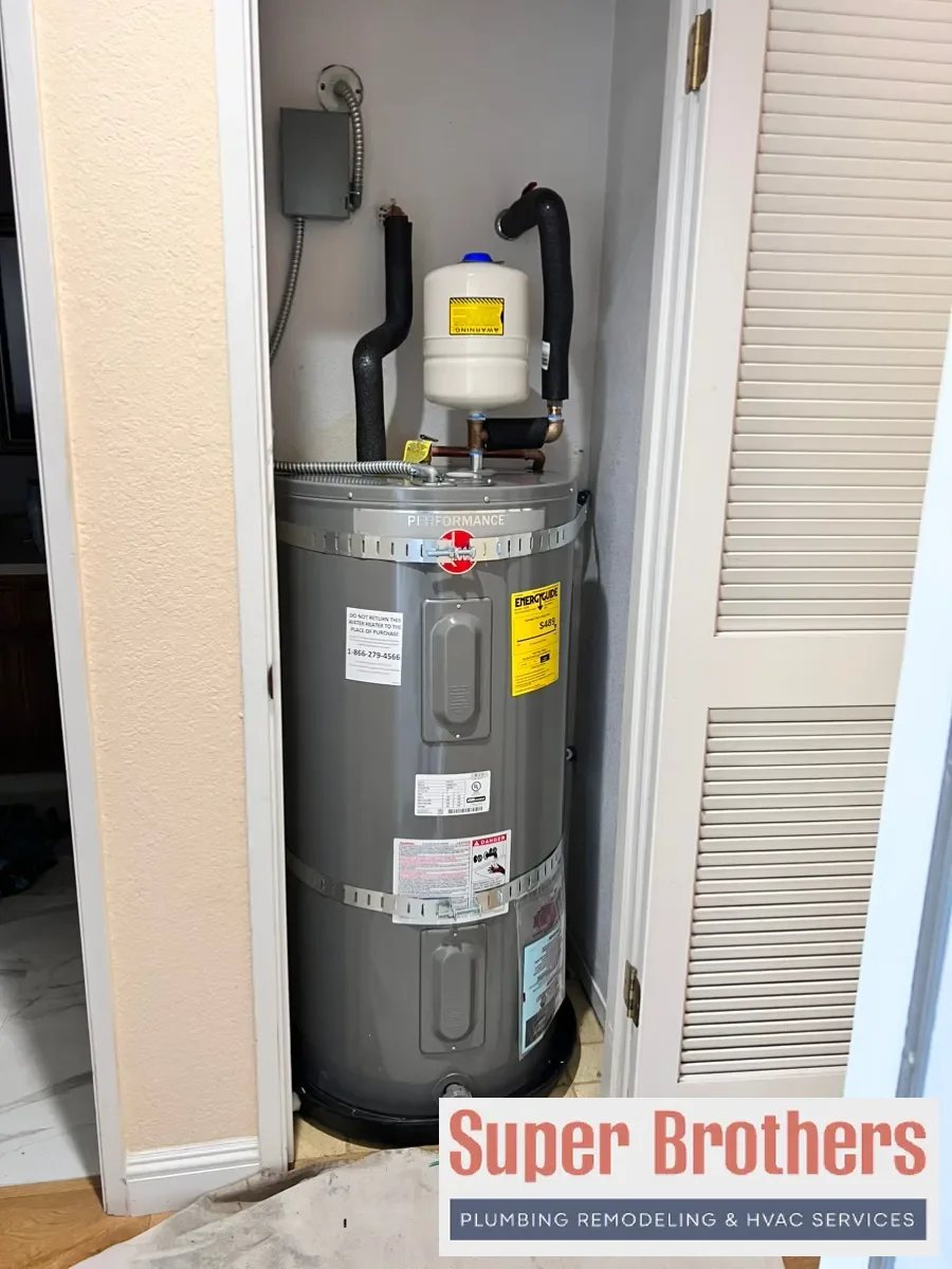 Heat pump water heater installed with proper clearance and condensate drain in Sacramento