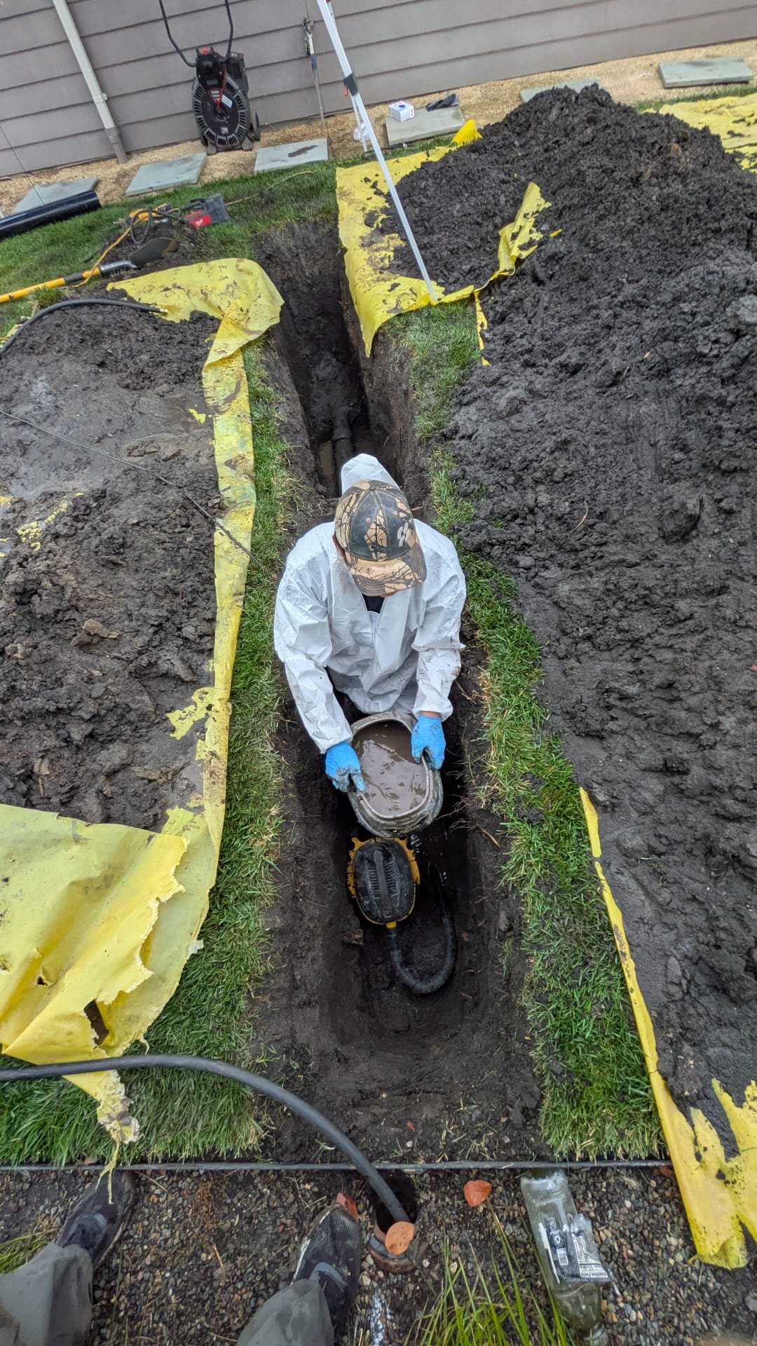 Plumber checking a sewer cleanout at a Sacramento home