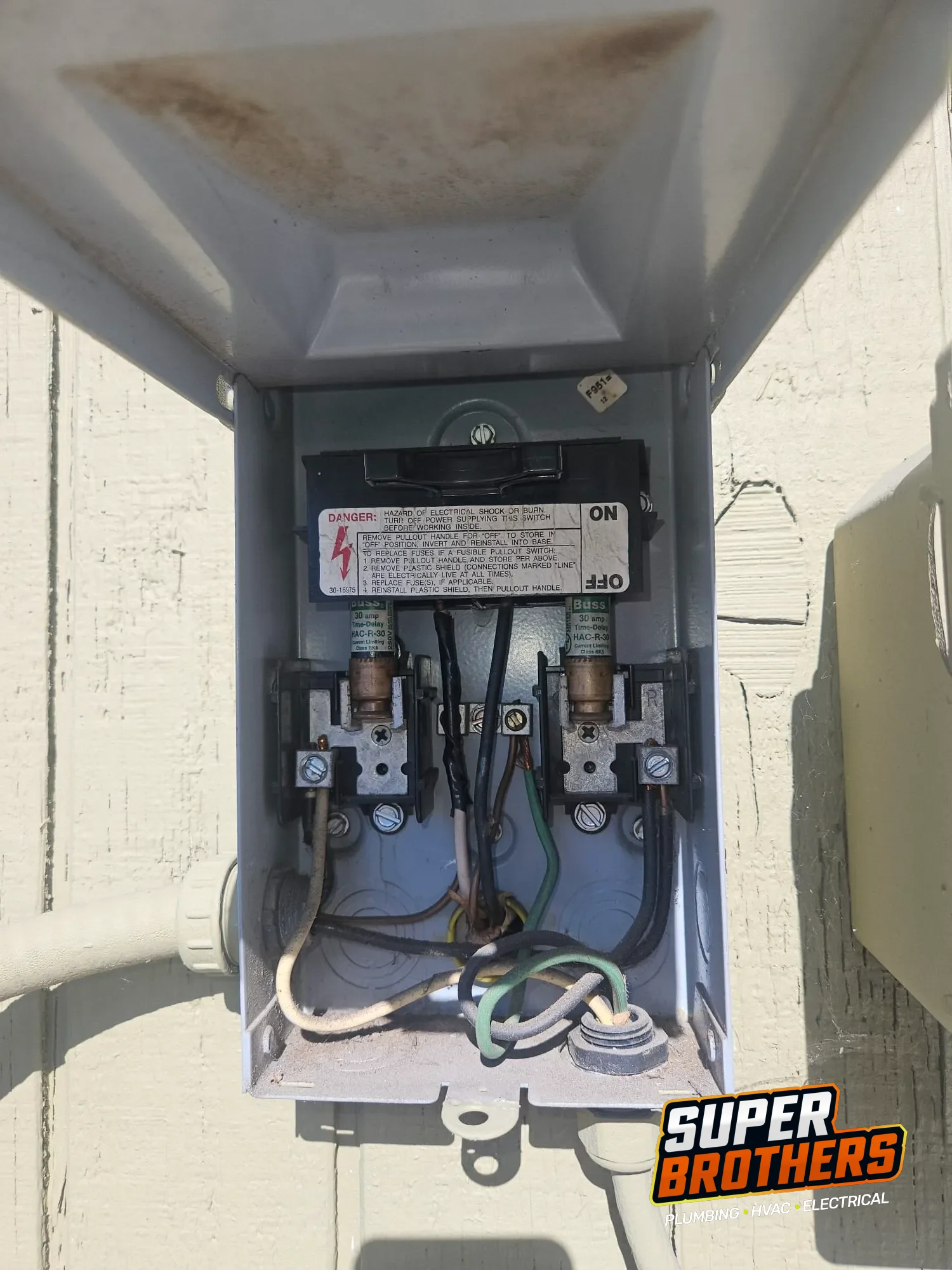 open AC disconnect box with fuses and wiring inspected open AC disconnect box with fuses and wiring inspected