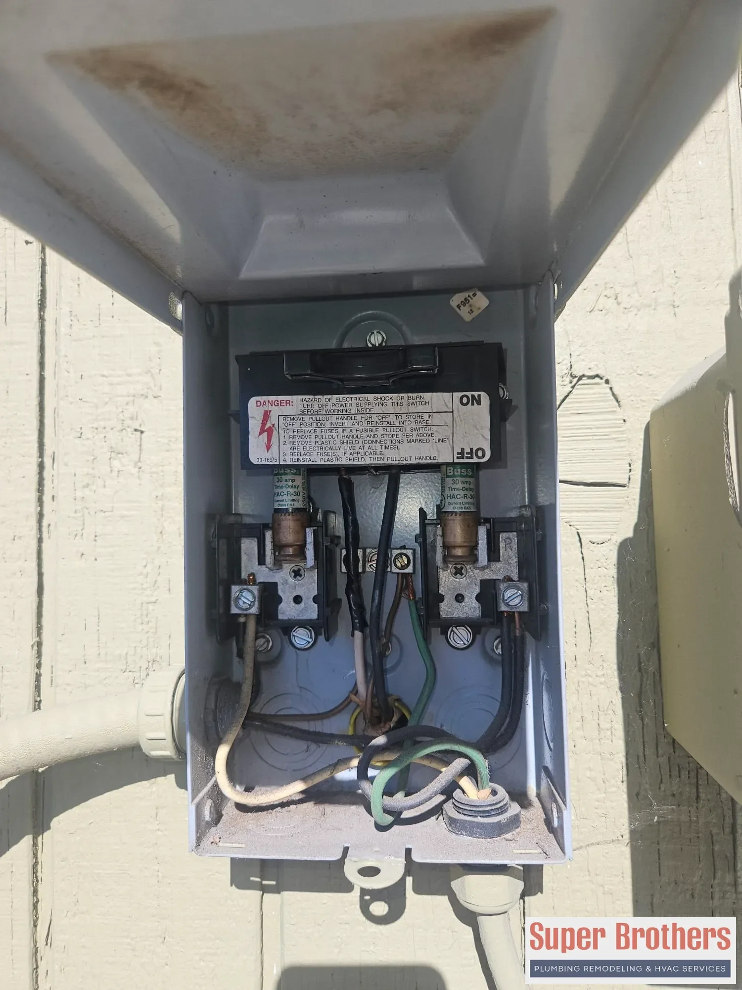 open AC disconnect box with fuses and wiring inspected open AC disconnect box with fuses and wiring inspected