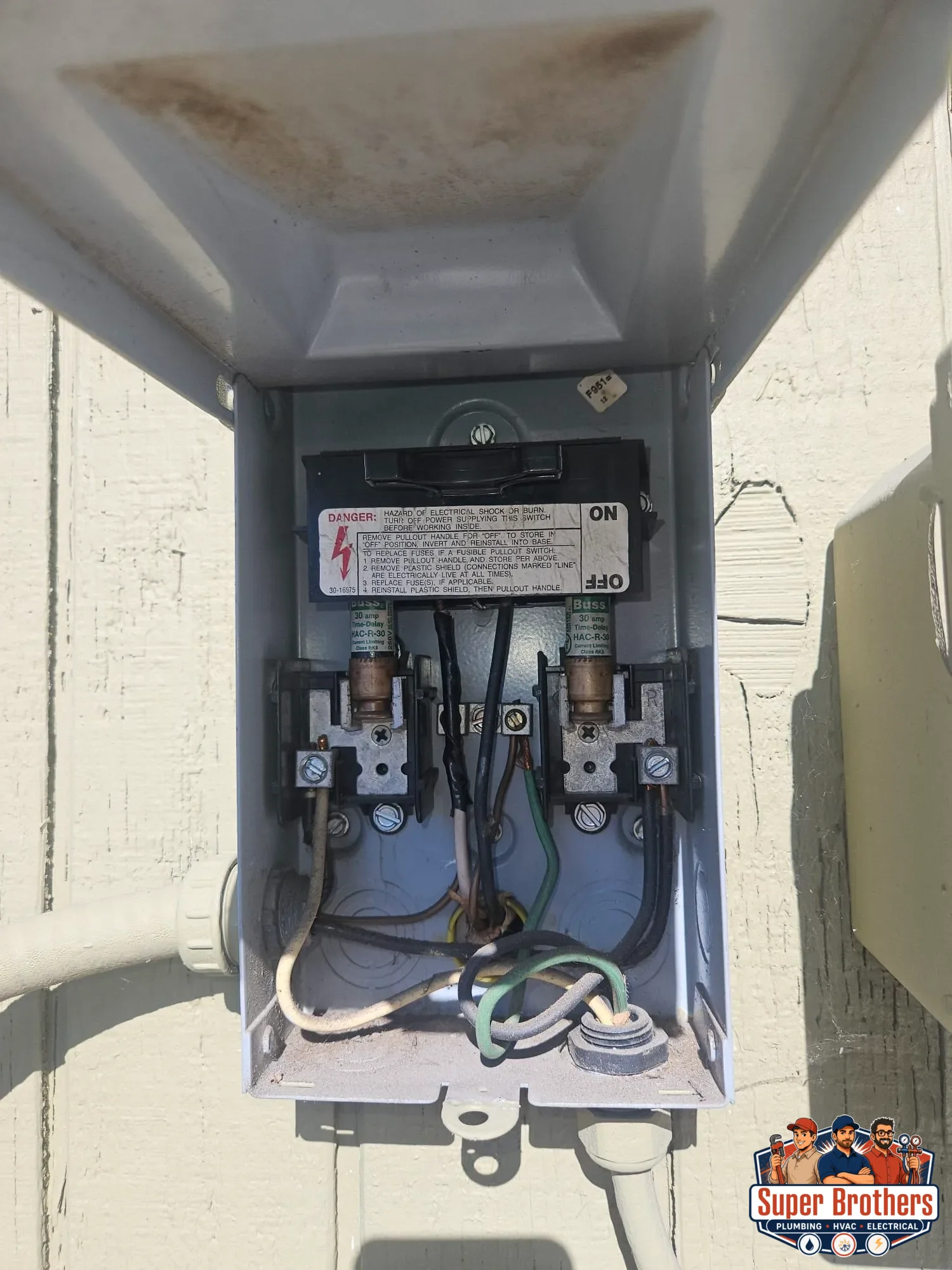 open AC disconnect box with fuses and wiring inspected