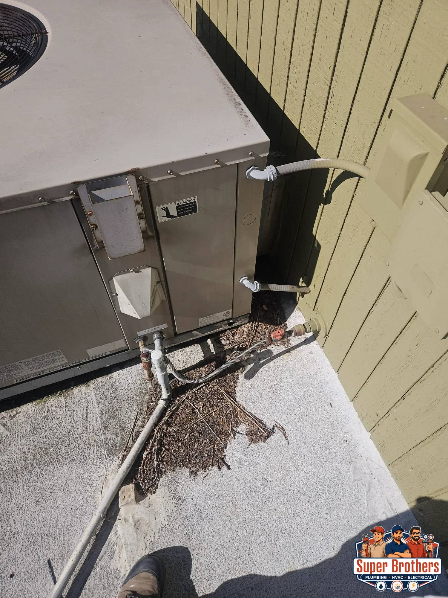 side access area of rooftop packaged AC unit with conduit and service connections