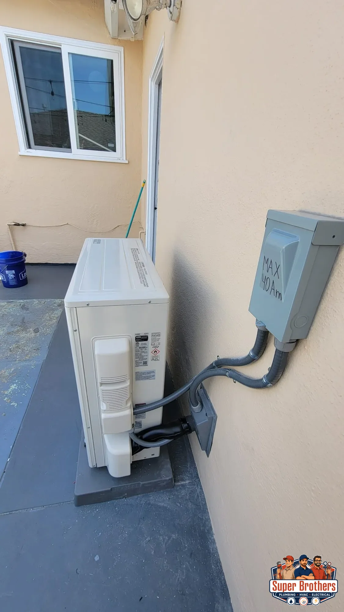 side view of Mitsubishi heat pump condenser with electrical whip and wall disconnect side view of Mitsubishi heat pump condenser with electrical whip and wall disconnect