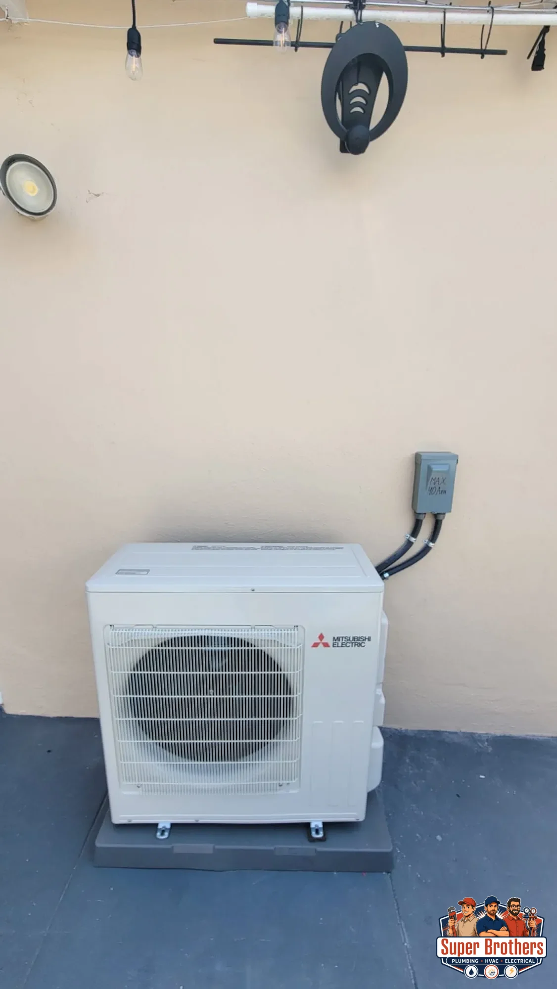 front view of installed Mitsubishi outdoor heat pump condenser on condenser pad front view of installed Mitsubishi outdoor heat pump condenser on condenser pad